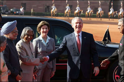 President George W. Bush shakes the hand of India's President A.P.J. Abdul Kalam as he and Mrs. Laura Bush are greeted upon their arrival at Rashtrapati Bhavan, the President's official residence in New Delhi Thursday, March 2, 2006. Also present are Prime Minister Manmohan Singh and his wife, Gusharan Kaur.