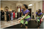 President George W. Bush and Mrs. Laura Bush join Liberia's President Ellen Johnson Sirleaf in viewing a dance performance by Moving in the Spirit, on the State Floor of the White House, Tuesday, March 21, 2006, prior to a social luncheon in honor of President Sirleaf.