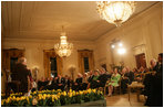 President George W. Bush and Mrs. Laura Bush join their invited guests in listening to Benjamin Franklin interpreter, Ralph Archbold of Philadelphia, Pa., Thursday evening, March 23, 2006 in the East Room of the White House, during a Social Dinner to honor the 300th birthday of Benjamin Franklin.