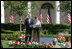 Mrs. Laura Bush and President George W. Bush address guests in the Rose Garden during an event honoring the recipients of the Preserve America Presidential Awards May 1, 2006.