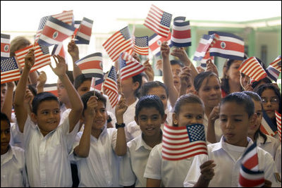 Students wave Costa Rican and American flags during Mrs. Bush's visit to their school, Escuela de los Estados Unidos, in San Jose, Costa Rica, Monday, May 8, 2006.