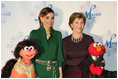 Mrs. Laura Bush stands with Her Majesty Queen Rania Al-Abdullah of Jordan and Sesame Street characters Khokha, left, and Elmo during a dinner celebrating the partnership between the Sesame Workshop and the Mosaic Foundation at the National Building Museum in Washington, D.C., Wednesday, May 9, 2006. Founded by the spouses of Arab Ambassadors to the United States, the Mosaic Foundation is dedicated to improving the lives of women and children.
