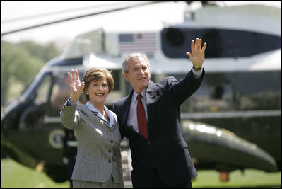 President George W. Bush and Mrs. Laura Bush wave to guests on the South Lawn Friday, May 12, 2006, before boarding Marine One en route Camp David.