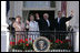 President George W. Bush, Prime Minister John Howard, Mrs. Laura Bush and Mrs. Janette Howard wave from the South Portico of the White House during the State Arrival Ceremony on the South Lawn Tuesday, May 16, 2006.