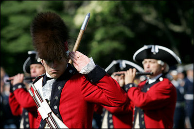 The Old Guard Fife and Drum Corps marches past President George W. Bush and Australian Prime Minister John Howard during a State Arrival Ceremony May 16, 2006 at The White House.