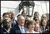 President George W. Bush and Laura Bush, seen holding an Olympic torch, pose with the 2006 U.S. Winter Olympic and Paralympic teams during a congratulatory ceremony held on the South Lawn at the White House Wednesday, May 17, 2006.