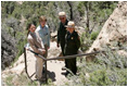 Mrs. Laura Bush pauses for a photo while hiking in Mesa Verde National Park in Colorado with, from left, Lynn Scarlett, Acting Secretary of the U.S. Department of Interior, Fran Mainella, Director, National Park Service and Larry Wiese, Superintendent of Mesa Verde National Park on Tuesday, May 23, 2006. Mesa Verde, founded as a national park on June 29, 1906, is celebrating its Centennial Anniversary this year.