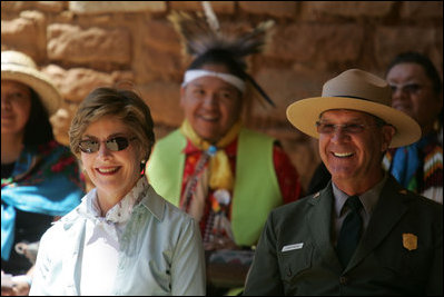 Mrs. Laura Bush and Mesa Verde National Park Superintendent Larry Wiese share a laugh, Thursday, May 23, 2006, during the celebration of the 100th anniversary of Mesa Verde and the Antiquities Act in Mesa Verde, Colorado. Also pictured are members of the Ute Mountain Ute Tribe.