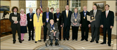 President George W. Bush and Mrs. Laura Bush stand with the recipients of the 2006 National Medal of Arts in the Oval Office Thursday, Nov., 9, 2006. Pictured from left, they are: Ben Jaffe and his mother Sandra Jaffe, director and co-founder of the Preservation Hall Jazz Band; Literary Translator Gregory Rabassa; Dancer Cyd Charisse; Photographer Roy DeCarava; Industrial Designer Viktor Schreckengost; Musician Dr. Ralph Stanley; Arts patron Billie Holladay; Composer William Bolcom; Interlochen Center for the Arts CEO Jeffrey Kimpton; and NEA Chairman Dana Gioia. 