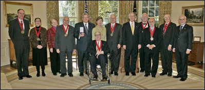 President George W. Bush and Mrs. Laura Bush stand with the 2006 National Humanities Medal recipients in the Oval Office Thursday, Nov., 9, 2006. Pictured from left, they are: Mark Noll, historian of religion; Mary Lefkowitz, classicist; Meryle Secrest, biographer; Bernard Lewis, Middle Eastern scholar; John Raisian senior fellow and director of the Hoover Institution; Robert Fagles, translator and classicist; Nickolas Davatzes, historian; Kevin Starr, historian; Fouad Ajami, Middle Eastern studies scholar; James Buchanan, economist; and NEH chairman Bruce Cole.