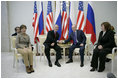 President George W. Bush and Russia's President Vladimir Putin exchange handshakes Wednesday, Nov. 15, 2006, as Mrs. Laura Bush and Lyudmila Putina look on. The brief Moscow stop was the first on the President and First Lady's week-long trip.