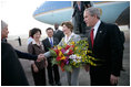 President George W. Bush looks on as Laura Bush is greeted by Patricia L. Herbold, U.S. Ambassador to Singapore, upon their arrival at Paya Lebar Airport Thursday, Nov. 16, 2006, for a two-day visit.