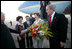 President George W. Bush looks on as Laura Bush is greeted by Patricia L. Herbold, U.S. Ambassador to Singapore, upon their arrival at Paya Lebar Airport Thursday, Nov. 16, 2006, for a two-day visit.