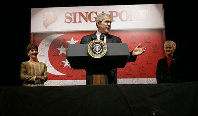 President George W. Bush addresses U.S. embassy staff and families during an embassy greeting in Singapore Thursday, November 16, 2006. U.S. Ambassador Patricia Herbold is pictured at the right.