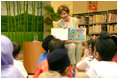 Mrs. Laura Bush reads Miss Spider's Tea Party during her visit Thursday, Nov. 16, 2006, to the National Library Building's Children's Reading Room in Singapore. Afterward, Mrs. Bush participated in a brief question-and-answer session with the kids. 