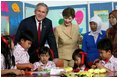 President George W. Bush and Mrs. Laura Bush pose with 6th graders during a drop-by education event Monday, Nov. 20, 2006, at the Bogor Palace in Bogor, Indonesia.