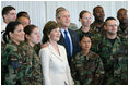 President George W. Bush and Laura Bush pose for photos with military personnel during a breakfast Tuesday, Nov. 21, 2006, at the Officers Club at Hickam Air Force Base in Honolulu, Hawaii.