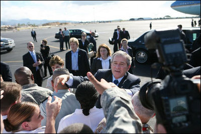President George W. Bush and Laura Bush shake hands with military personnel as they prepare to depart Honolulu, Hawaii, Tuesday, Nov. 21, 2006, for their flight home to Washington, D.C., following their eight-day trip to Asia.