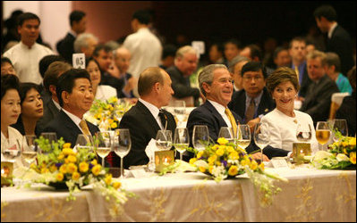 President George W. Bush and Mrs. Laura Bush enjoy the APEC gala dinner and cultural performance Saturday, Nov. 18, 2006, at the National Convention Center in Hanoi. They are seated with President Vladimir Putin of Russia, and President Roh Moo-hyun of the Republic of Korea, left, and Prime Minister Helen Clark of New Zealand, right.