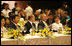 President George W. Bush and Mrs. Laura Bush enjoy the APEC gala dinner and cultural performance Saturday, Nov. 18, 2006, at the National Convention Center in Hanoi. They are seated with President Vladimir Putin of Russia, and President Roh Moo-hyun of the Republic of Korea, left, and Prime Minister Helen Clark of New Zealand, right.