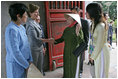 Mrs. Laura Bush is greeted as she arrives at the Temple of Literature in Hanoi Saturday, Nov. 18, 2006, for a tour with the spouses of APEC leaders.