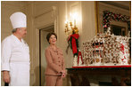 Mrs. Laura Bush and former chef Roland Mesnier discuss the gingerbread White House with the press in the State Dining Room Thursday, Nov. 30, 2006. The house consists of more than 300 pounds of dark chocolate and gingerbread.