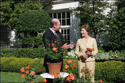 Mrs. Laura Bush smiles at Bill Williams, President and CEO of Harry & David Holdings, Monday, October 2, 2006, as she participates in a ceremony for the unveiling of the Laura Bush rose in The First Lady's Garden at The White House. Founded in 1872, Jackson & Perkins is a leading hybridizer of garden roses and has launched The Laura Bush rose as part of the First Ladies Rose Series. The rose is a floribunda rose and has light yellow buds that open to a smoky coral color with yellow on the reverse petal.