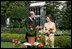 Mrs. Laura Bush smiles at Bill Williams, President and CEO of Harry & David Holdings, Monday, October 2, 2006, as she participates in a ceremony for the unveiling of the Laura Bush rose in The First Lady's Garden at The White House. Founded in 1872, Jackson & Perkins is a leading hybridizer of garden roses and has launched The Laura Bush rose as part of the First Ladies Rose Series. The rose is a floribunda rose and has light yellow buds that open to a smoky coral color with yellow on the reverse petal.