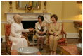Mrs. Laura Bush visits with Mrs. Emine Erdogan, wife of Prime Minister Recep Tayyip Erdogan of Turkey , in the Yellow Oval Room in the private residence of the White House Monday, October 2, 2006.