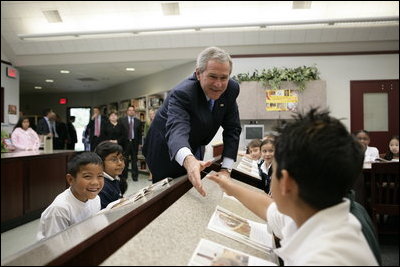 President George W. Bush greets students during a tour of the Laura Bush Library at George W. Bush Elementary School in Stockton, Calif., Tuesday, Oct. 3, 2006.
