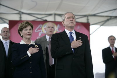 President George W. Bush and Mrs. Laura Bush stand for the National Anthem during the Christening Ceremony of the George H.W. Bush (CVN 77) in Newport News, Virginia, Saturday, Oct. 7, 2006.