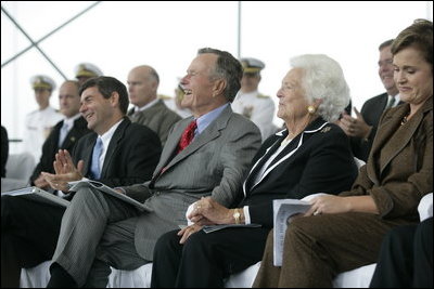 Former President George H. W. Bush and First Lady Barbara Bush react during remarks by President George W. Bush during the Christening Ceremony for the George H.W. Bush (CVN 77) in Newport News, Virginia, Saturday, Oct. 7, 2006.