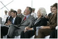 Former President George H. W. Bush and First Lady Barbara Bush react during remarks by President George W. Bush during the Christening Ceremony for the George H.W. Bush (CVN 77) in Newport News, Virginia, Saturday, Oct. 7, 2006.