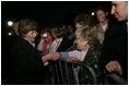 Mrs. Laura Bush greets members of the audience members that include representatives from breast cancer organizations, supporters of breast cancer research, breast cancer survivors and local residents during the Arch Lighting for Breast Cancer Awareness Thursday, Oct. 12, 2006, in St. Louis.