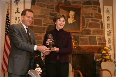 John Long, Chairman of the Board of Directors, Pearl S. Buck International, presents Mrs. Laura Bush with the 2006 Pearl S. Buck Woman of the Year award Tuesday, October 24, 2006, at the Pearl S. Buck House in Perkasie, Pennsylvania. The Pearl S. Buck award is given to honor women who make outstanding contributions in the areas of cross-cultural understanding, humanitarian outreach, and improving the life and expanding opportunities for children around the world.