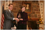John Long, Chairman of the Board of Directors, Pearl S. Buck International, presents Mrs. Laura Bush with the 2006 Pearl S. Buck Woman of the Year award Tuesday, October 24, 2006, at the Pearl S. Buck House in Perkasie, Pennsylvania. The Pearl S. Buck award is given to honor women who make outstanding contributions in the areas of cross-cultural understanding, humanitarian outreach, and improving the life and expanding opportunities for children around the world.