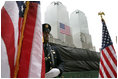 A police officer stands at attention at Ground Zero during the ceremonies marking the fifth anniversary of the September 11th terrorist attacks in New York City Sunday, September 10, 2006.