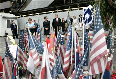 During their visit to Ground Zero, President George W. Bush and Laura Bush look at a memorial created from some of the objects visitors have brought to the site in New York City Sunday, September 10, 2006.