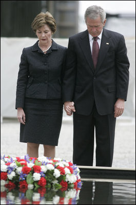 President George W. Bush and Laura Bush stand in silence after laying a wreath in the north reflecting pool at Ground Zero September 10, 2006, in commemoration of the fifth anniversary of the terrorist attacks of September 11, 2001, on the World Trade Center in New York City.