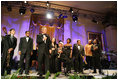 President George W. Bush stands with performers on stage in the East Room Thursday night, Sept. 14, 2006, as he offers closing remarks to guests at the Thelonious Monk Institute of Jazz dinner at the White House.