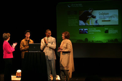 Watching the launch of a new Pakistani cultural and arts website, Mrs. Laura Bush stands with student Shaan Mihza of Eleanor Roosevelt High School, left; student Timothy Brown of Chantilly High School, and Mrs.Sehba Musharraf, wife of Pakistan's President Pervez Musharraf, Thursday, Sept. 21, 2006, at The John F. Kennedy Center for the Performing Arts in Washington, D.C. The website is created by the Pakistan National Council the Arts and The Kennedy Center and is called, "Gift of the Indus: The Arts and Culture of Pakistan."