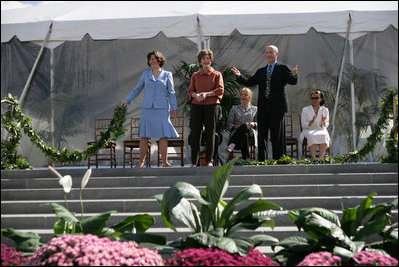 Mrs. Laura Bush joined by, left, Leone Reeder, Chair, National Fund for the U.S. Botanic Garden, and, right, Jim Hagedorn, Co-Chair, Board of Trustees, National Fund for the U.S. Botanic Garden, while the Ceremonial Garland is cut Friday, September 29, 2006, during a ceremony to celebrate the completion of the National Garden at the United States Botanic Garden in Washington, D.C. This new facility, located on a three-acre site just west of the Conservatory, will be a showcase for unusual, useful, and ornamental plants that grow well in the mid-Atlantic region.