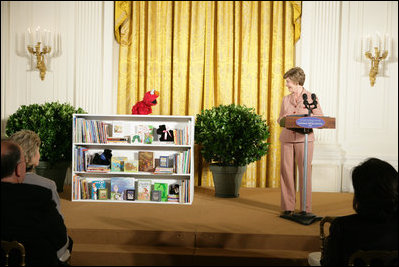 Mrs. Laura Bush talks with Elmo, a puppet on the children's television show Sesame Street, in the East Room of the White House, Saturday, September 30, 2006, during the seventh annual National Book Festival opening ceremony in Washington, D.C. The festival, held on the grounds of the National Mall, will include author readings, book signings, musical performances, and storytelling for children, adults and families. More than 80 noted authors and artists from around the country will participate.