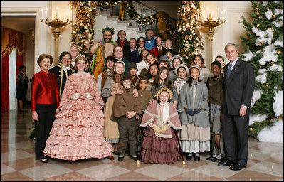President George W. Bush and Mrs. Laura Bush pose for a photo with the Ford Theater cast members of "A Christmas Carol," following their performance Monday, Dec. 3, 2007, at the White House Children's Holiday Reception.