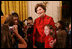 Mrs. Laura Bush poses for a photo with a young guest following the performance of the Ford Theater cast members presentation of "A Christmas Carol," Monday, Dec. 3, 2007, at the White House Children's Holiday Reception. 