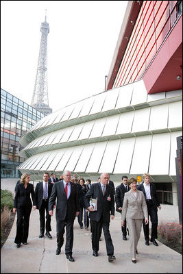 The Eiffel Tower stands tall in the background as Mrs. Laura Bush walks with Stephane Martin, President of the Musee du quai Branly, center, in Paris Monday, Jan. 15, 2007. Mrs. Bush toured the museum with US Ambassador Craig Stapleton, left, and his wife Mrs. Stapleton.