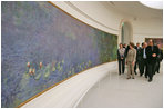 Mrs. Laura Bush tours the Musee de l'Orangerie with Director Pierre Georgel, right, and US Ambassador Craig Stapleton and his wife Mrs. Stapleton, left, in Paris Monday, Jan. 15, 2007. The Musee de l'Orangerie is home to eight paintings from Monet's large-format series of Water Lilies.