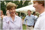 Mrs. Laura Bush surprises a caller on guest's cell phone Tuesday evening, June 19, 2007, at the annual White House Congressional Picnic on the South Lawn.