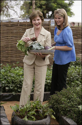 Mrs. Laura Bush and Ms. Jenna Bush pick vegetables during their visit to the Fann Hospital garden with Senegalese First Lady Viviane Wade and her daughter Tuesday, June 26, 2007, in Dakar, Senegal. Supported by USAID, the Fann Hospital gardens provide fresh vegetables to address the nutritional needs of patients with HIV/AIDS, an overlooked, but essential part of their care.
