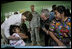 President George W. Bush and Mrs. Laura Bush play with a young girl during a visit Monday, March 12, 2007, to the Carlos Emilio Leonardo School in Santata Cruz Balanya, Guatemala. The couple visited a medical readiness and training exercise site at the school.
